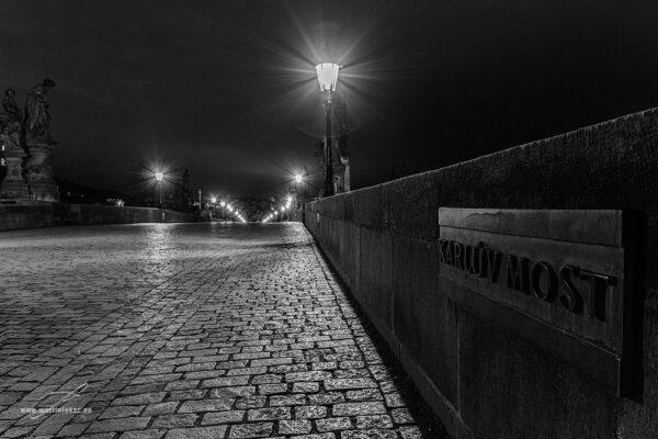 Covid zóna - Fotografie prázdného Karlova mostu v noci s osvícenými lampami a nápisem "Karlův most", autor Martin Lukač.