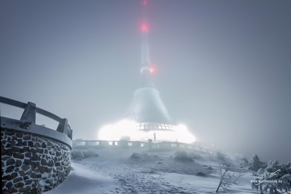 Ufo na Ještědu – Zasněžený vrchol Ještědu s nasvícenou televizní věží v mlze, autor Martin Lukač